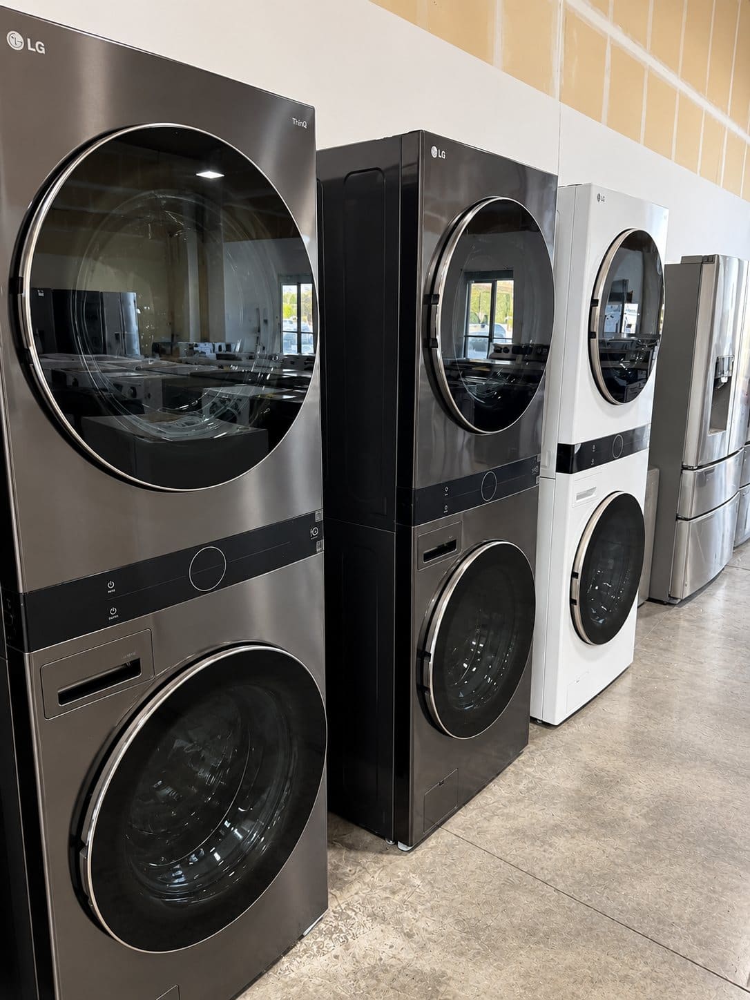 LG WashTower stacked washer and dryer units in black, graphite and white