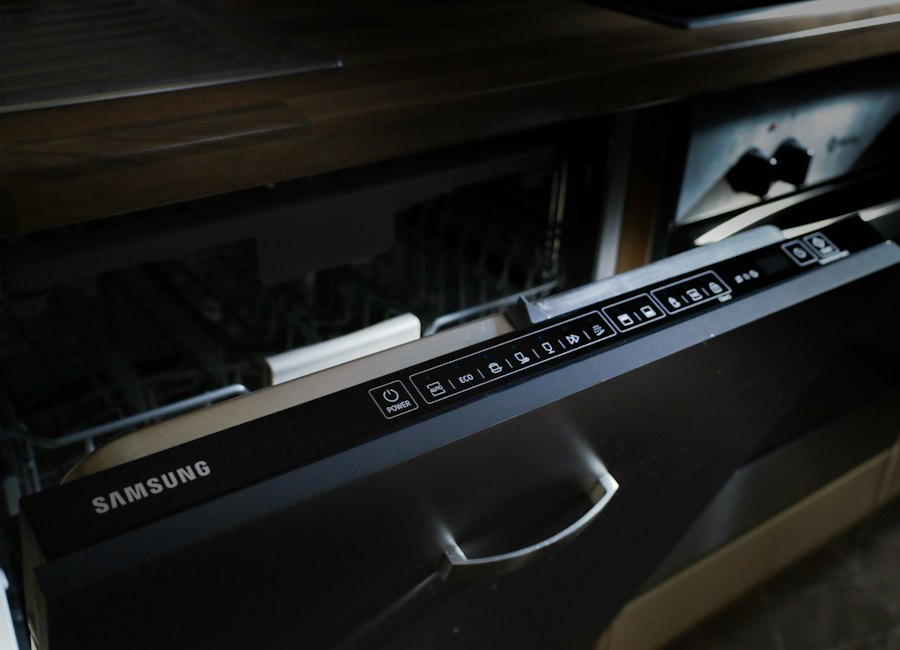 A modern dishwasher built into dark cabinetry