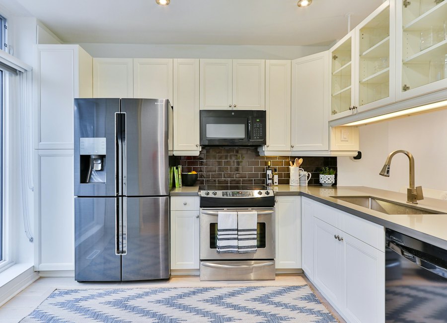 Silver french-door refrigerator beside kitchen cabinetry